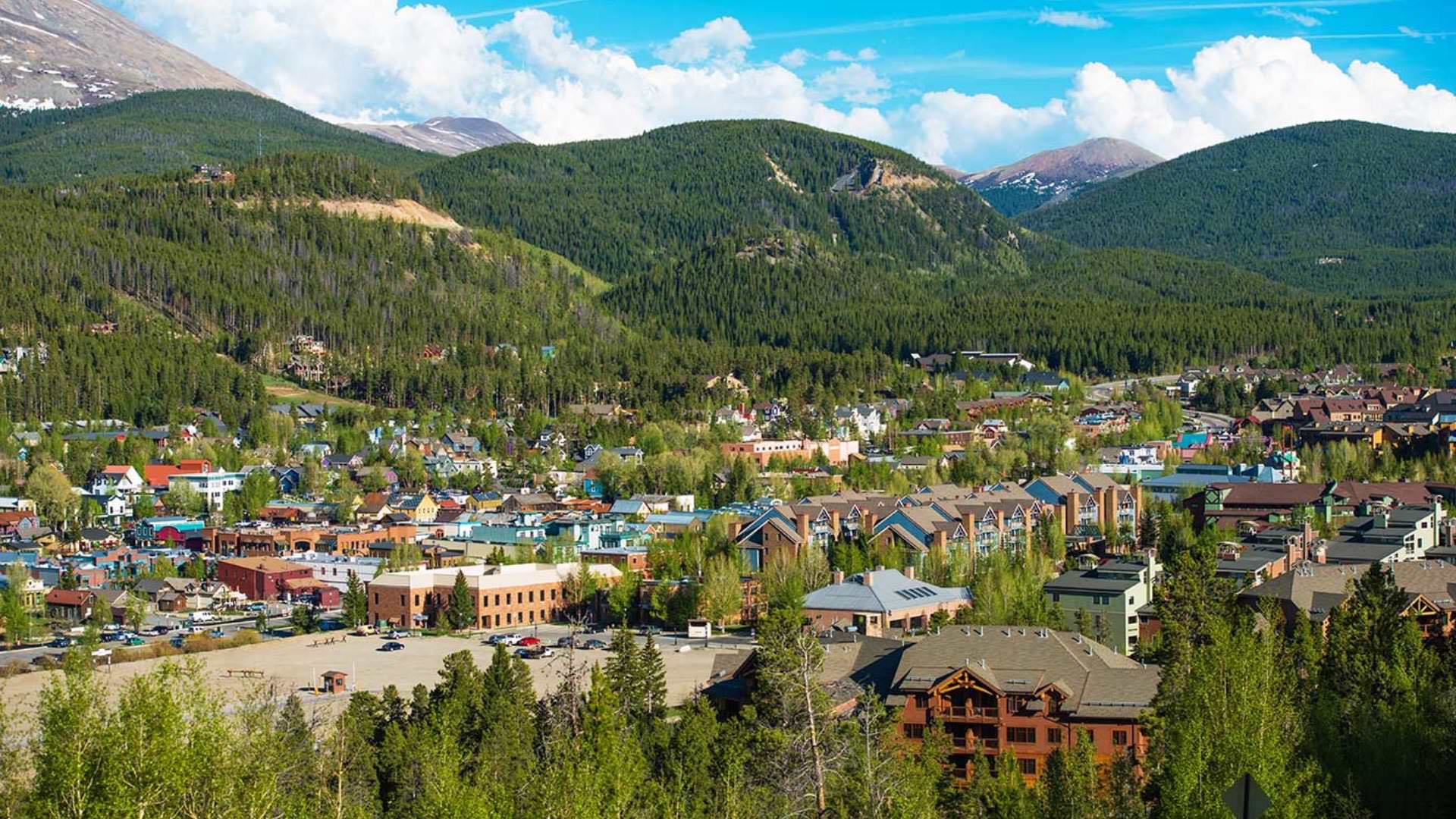 Small town surrounded by green trees in the mountains