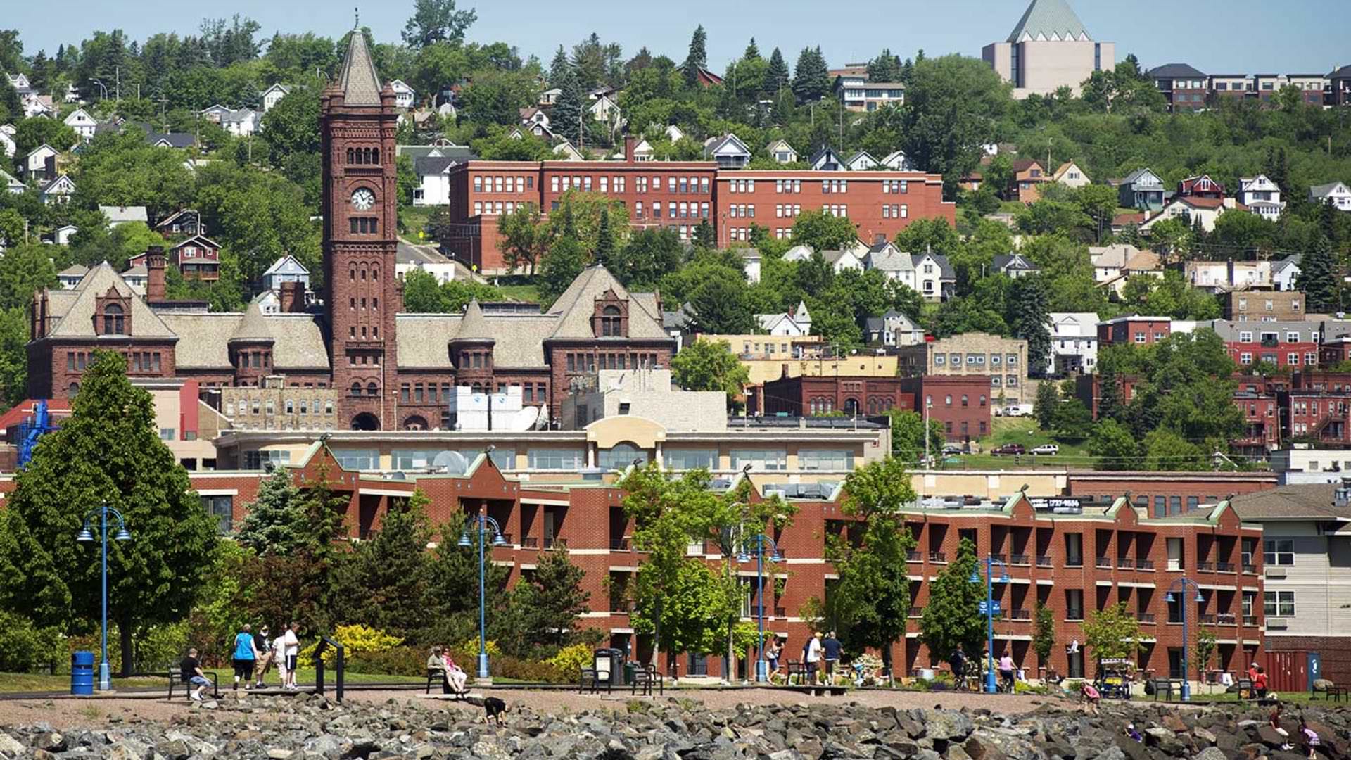 Hill covered with multiple buildings, houses, and green trees